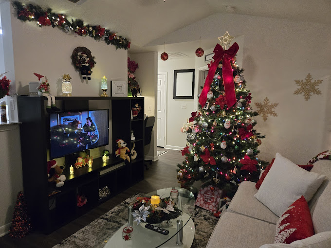 A living room decorated for christmas with a christmas tree