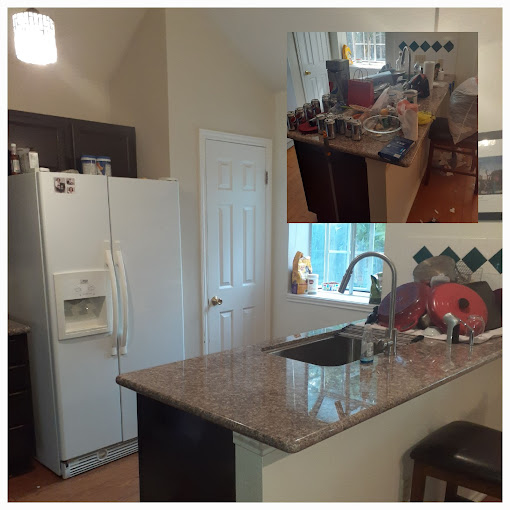 A kitchen with a sink and a refrigerator