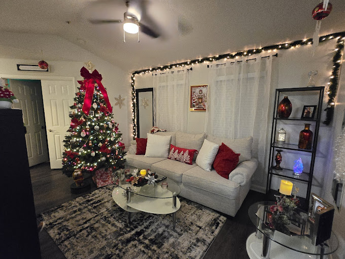 A living room decorated for christmas with a christmas tree